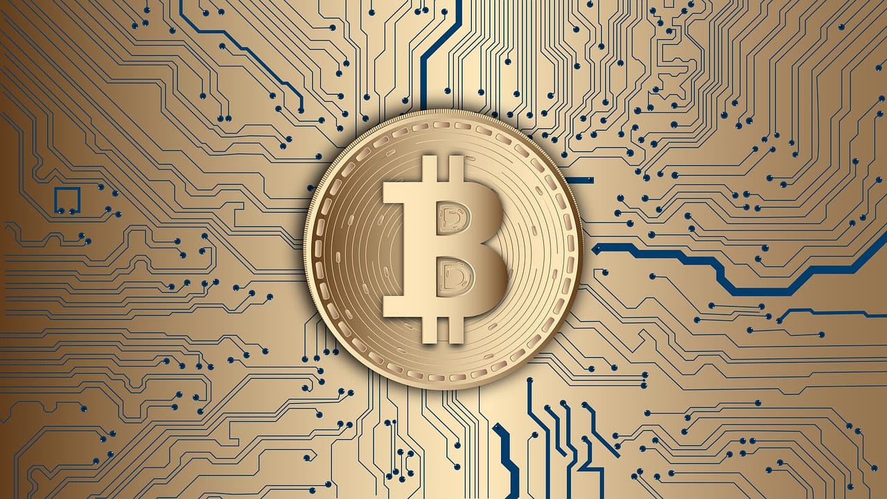 Illustration of a golden Bitcoin symbol on a blue and white glowing digital background, representing cryptocurrency and blockchain technology